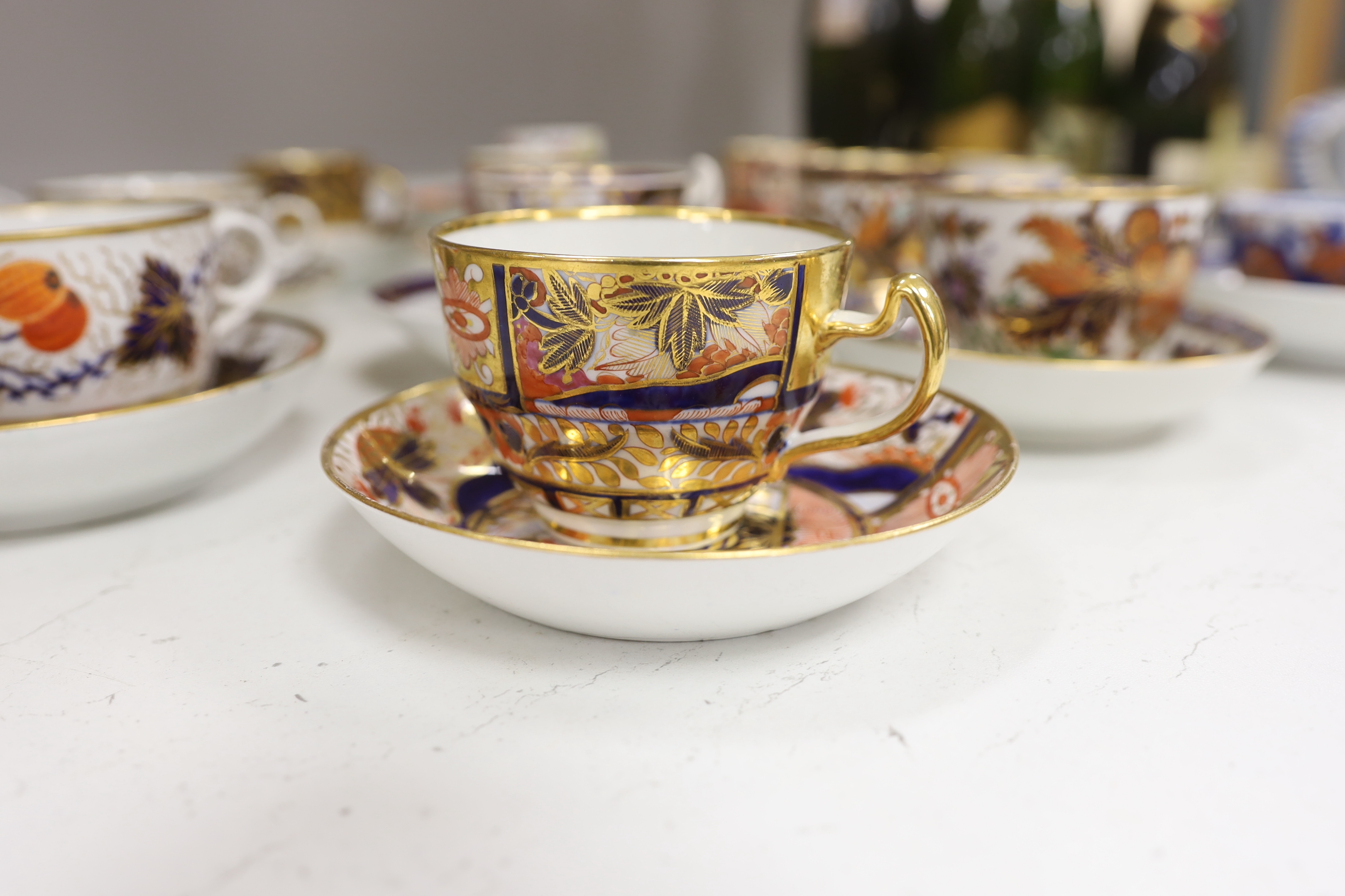 Six mixed English 1800-1820 porcelain cabinet cups and saucers, three similar coffee cans and saucers, a matching spoon stand and two coffee cans, a saucer dish, coffee can plus saucer and a tea bowl and matching saucer